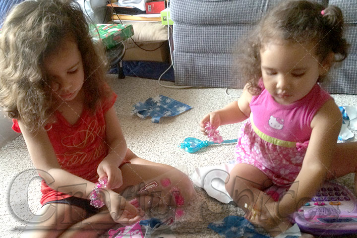 Kira and Kaylee opening gifts