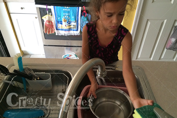 Kira washing dishes