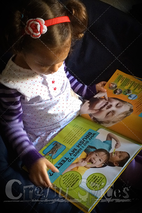 Kira enjoying a National Geographic book