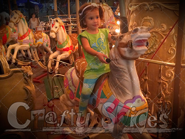 Kira having fun on carousel Kira having fun on carousel