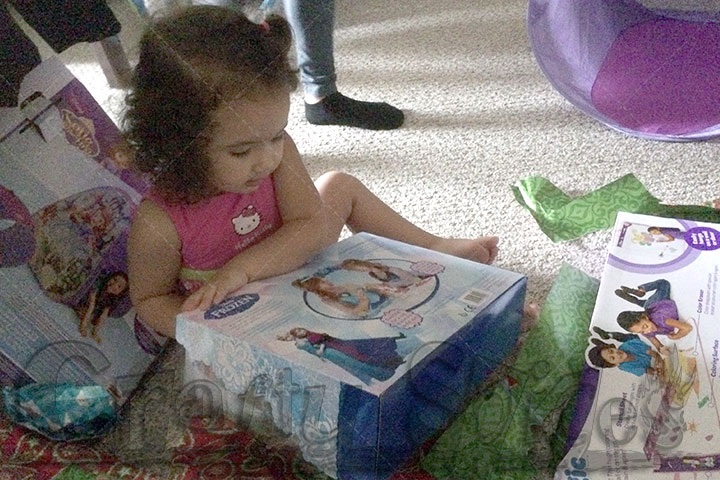 Kaylee opening her Frozen gift from Tio