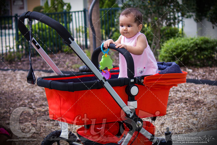 Kaylee standing in her stroller